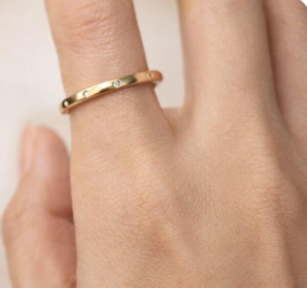 Delicate gold band ring with flush-set diamonds