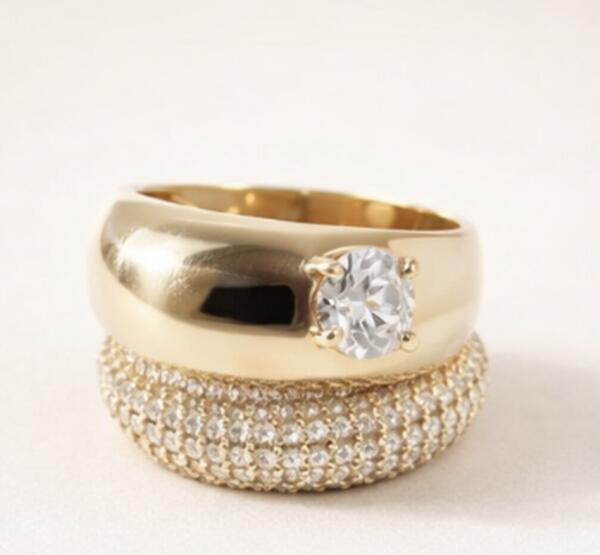 Gold solitaire diamond ring stacked with pavé diamond band